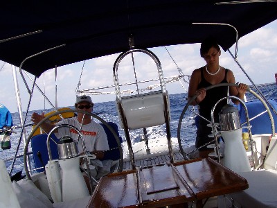 Here's us sailing on our way to Cozumel, while I show Roos the finer points of steering the boat under sail. 