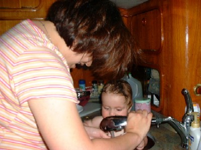 Janet, giving baby Lucas a bath in our galley's sink (he fit right in)