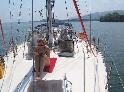 Saartje reading on deck as Andiamo motors during a lull in the wind.