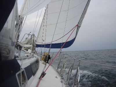 Andiamo making its way under sail across Lago Izabal